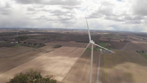 drone flying past blades of wind power propeller not spinning