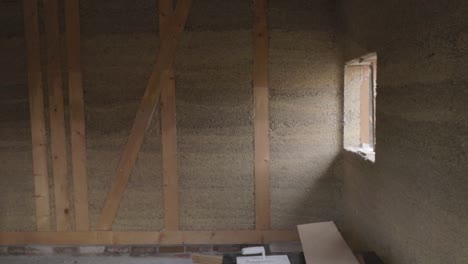 inside view of a hempcrete wall in wooden frame with windows unter construction