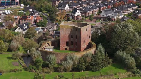 aerial view of a ruinous circular tower in a dutch village