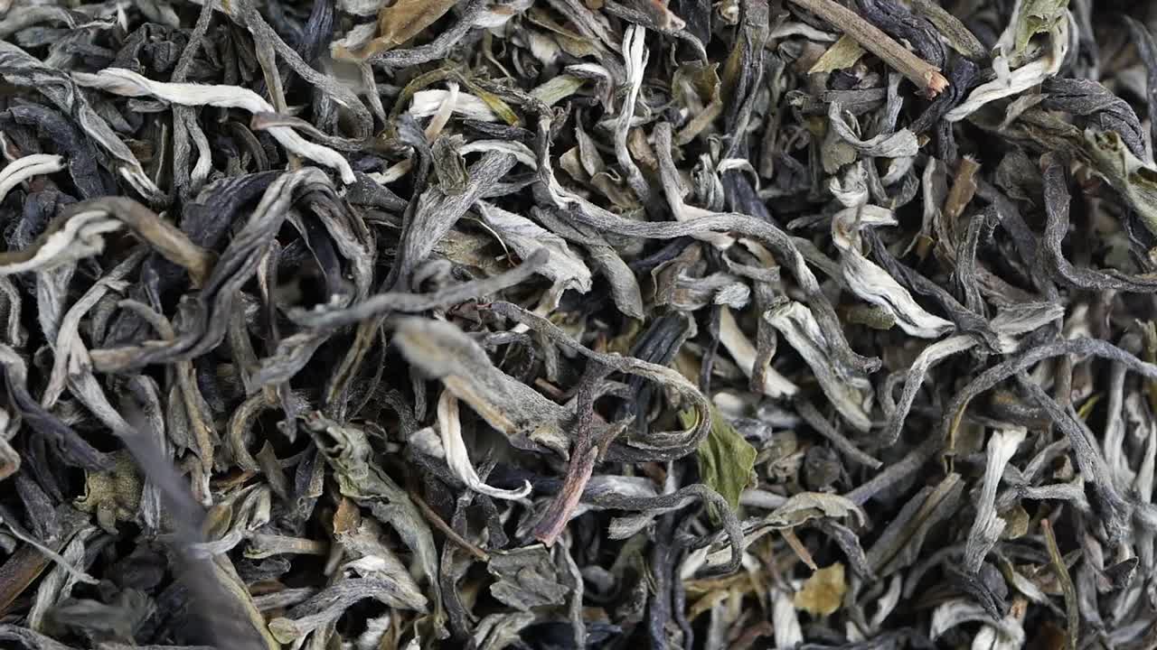 Close Up of Dried Tea Leaves Falling