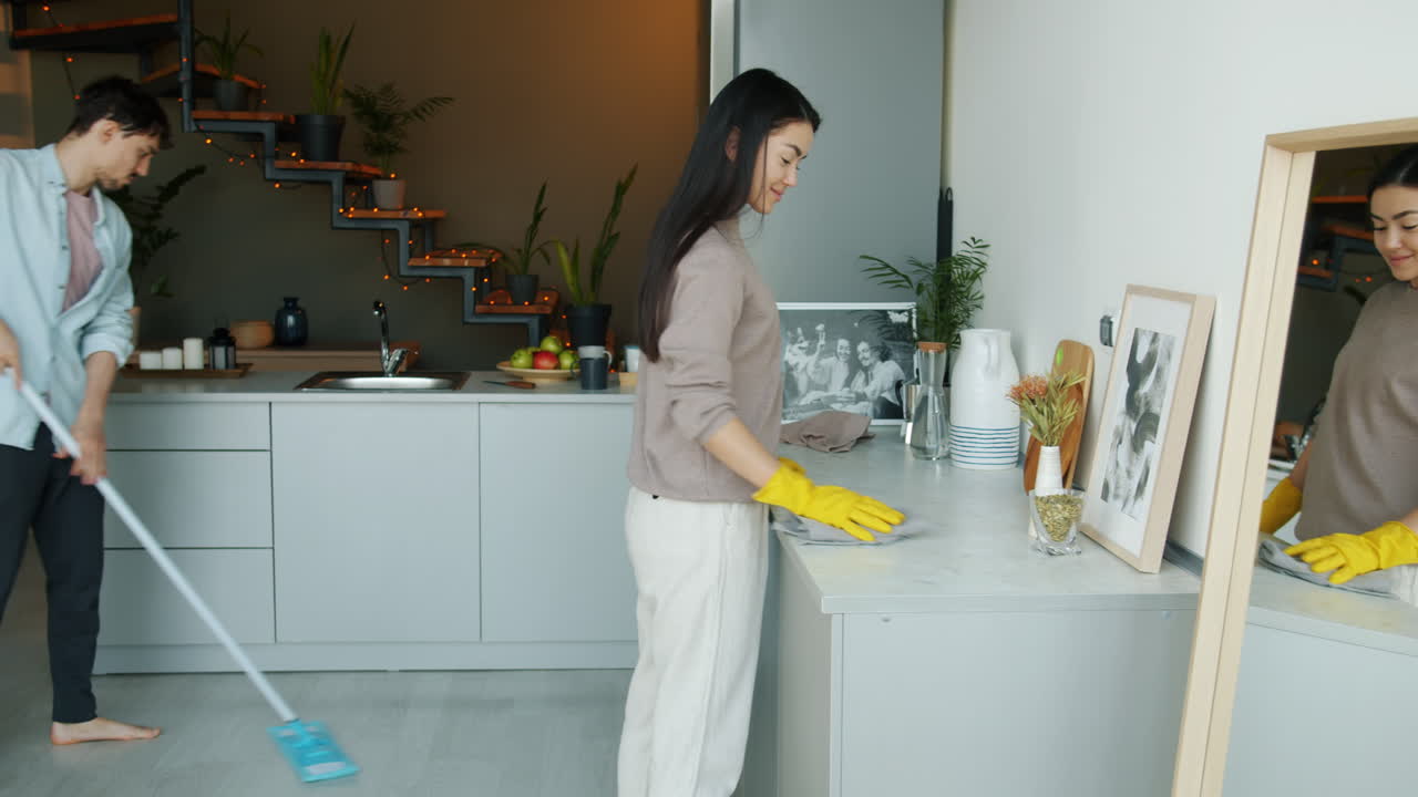 Couple Cleaning Kitchen