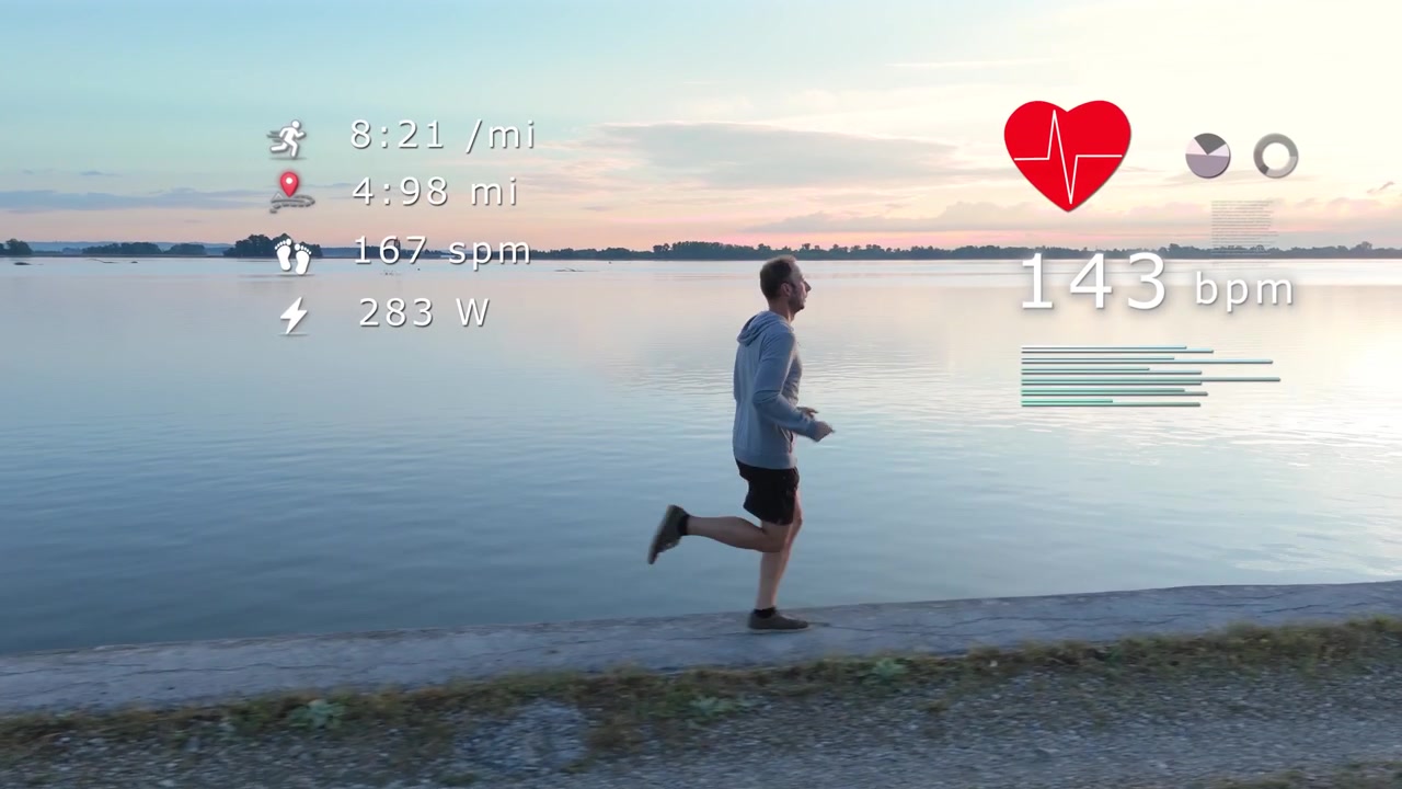 Aerial view of a male runner jogging by a river at sunrise with a futuristic smartwatch data HUD overlay. Displays heart rate, pace, cadence and power metrics for fitness tracking
