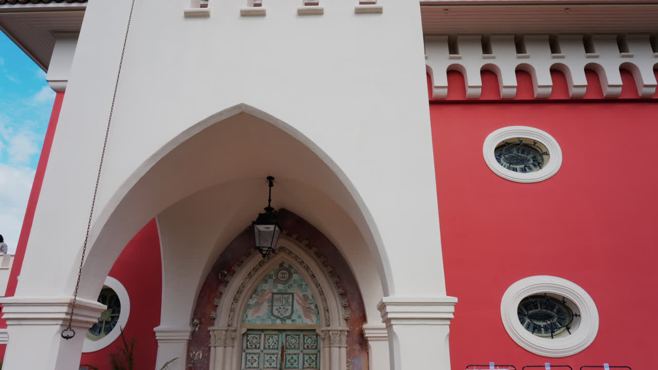 Nice, France - May 17, 2025: The red tower of the Cremat Castle Winery over the blue sky
