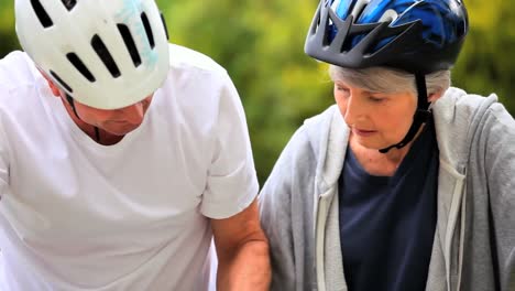 Mature-couple-getting-ready-for-riding-bicycles