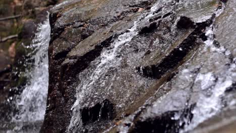 beautiful waterfall flowing in mountain. hidden waterfall in wet rock