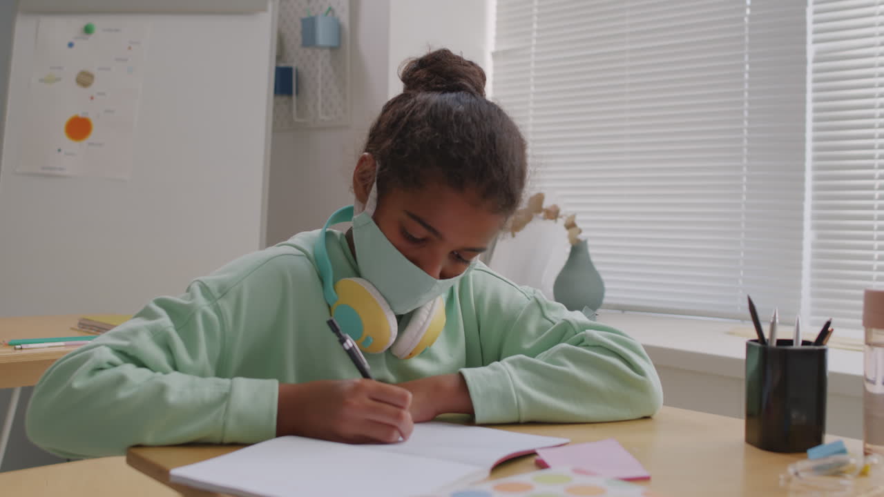 African-American 11-Year-Old Girl in Face Mask in Class