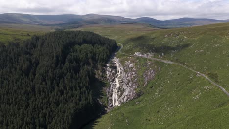 drone shot of a large waterfall in ireland on a sunny day