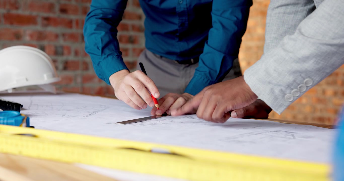 Architects Reviewing Construction Blueprints on a Table