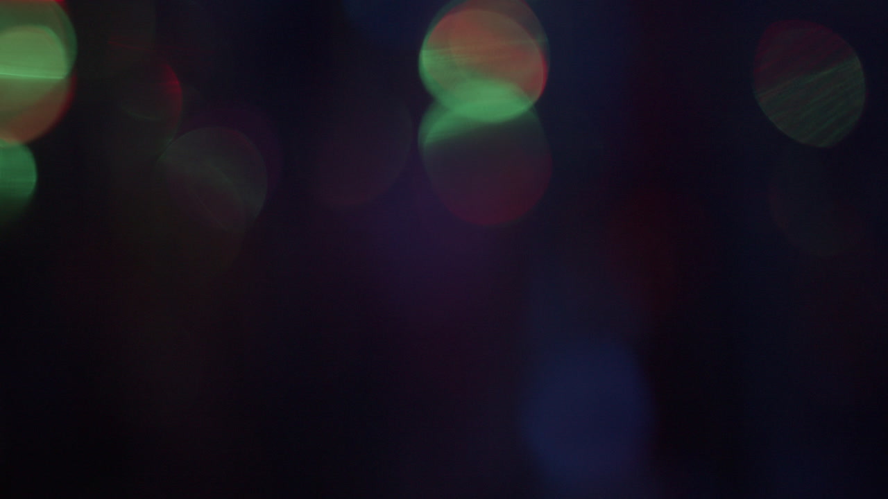 A curtain glitters in the neon lights