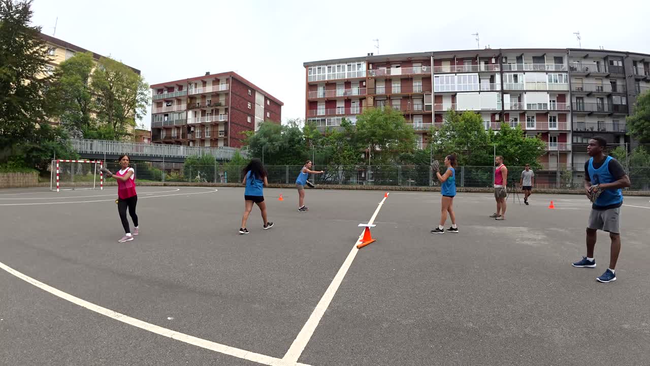 Group of people playing baseball outdoors