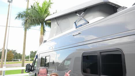 husband and wife customer that are happy with a new van camper with sleeping tent on top