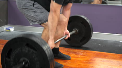 male performs a set of deadlift exercises at a gym