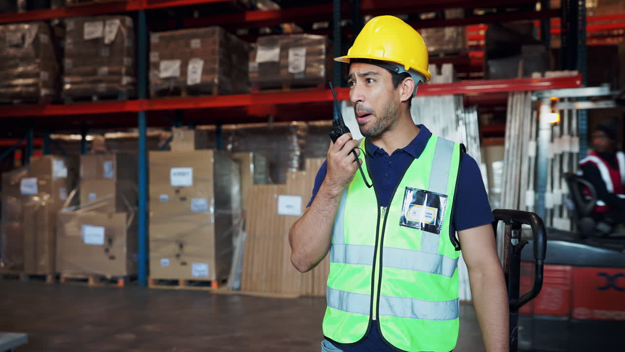 Warehouse worker communicating with walkie talkie