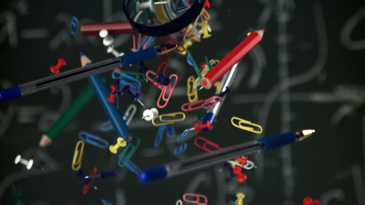 Colorful School and Office Supplies Floating Against a Chalkboard