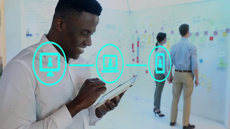 Animation of network of digital icons over portrait of happy african american using tablet at office
