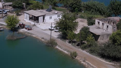 Farmer-driving-old-tractor-through-rural-Green-lake-rustic-village-in-the-Taurus-mountains-of-Turkey