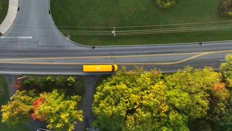 yellow school bus driving on suburban american street