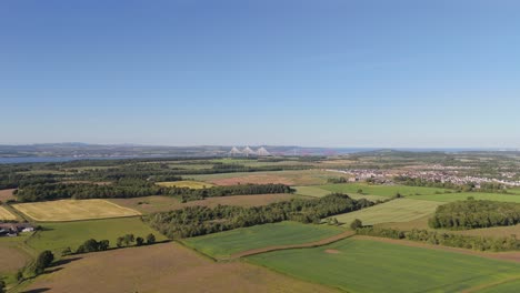 forth road bridges from a distance with farms in the foreground
