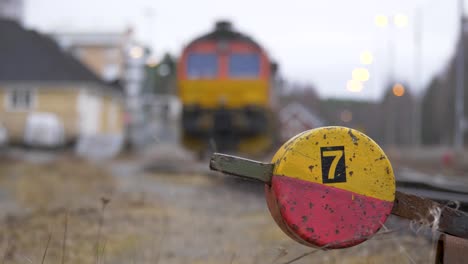 railway warning railroad switch sign in crossover station on a overcast day - medium shot