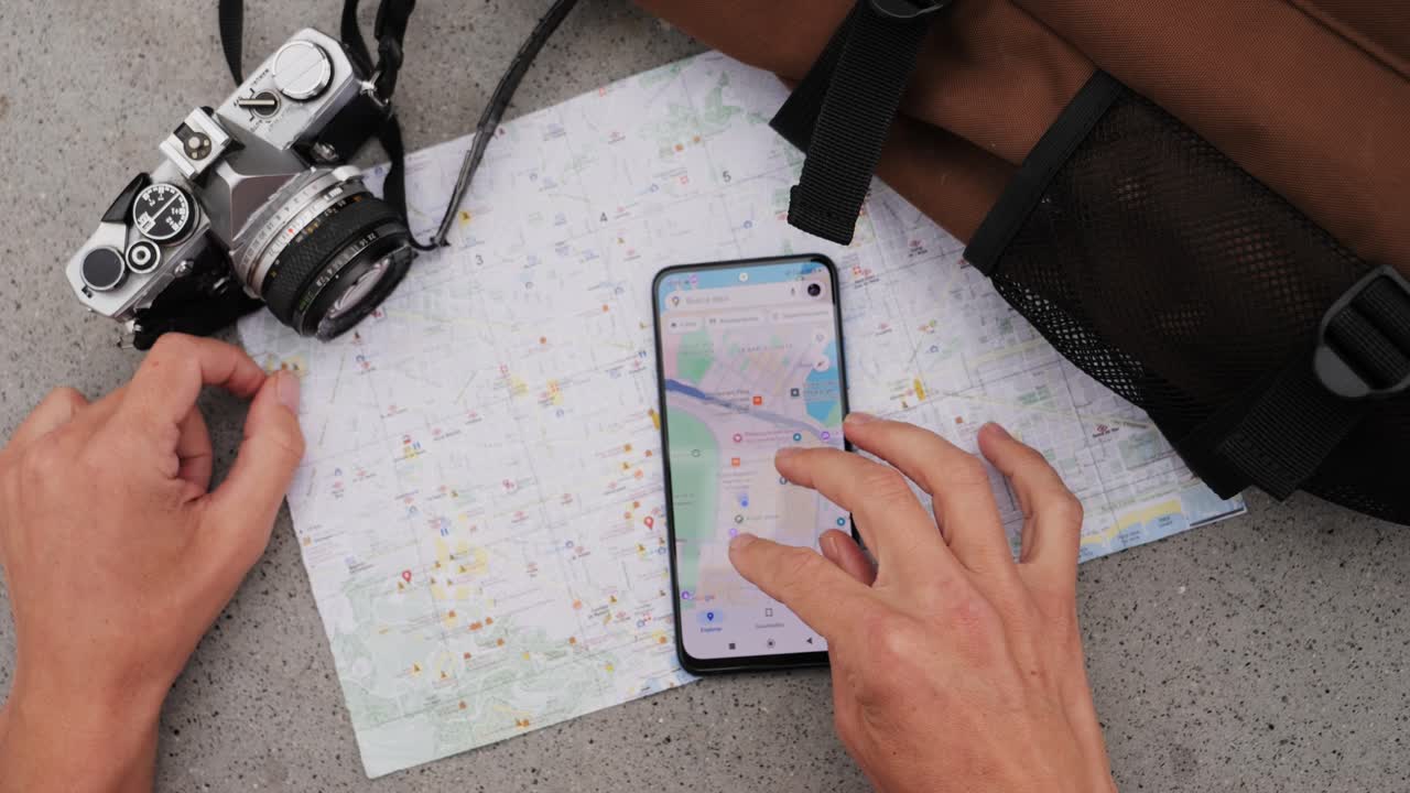 Man tourist using smart phone searching location in map application online close up macro. Backpacker using GPS to find destination on vacation. City or Forest hiking, walking in europe