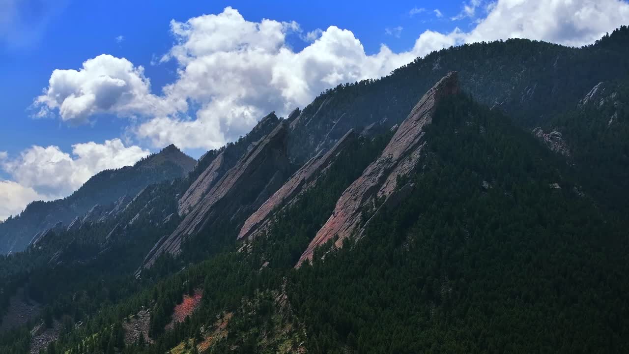 Green Flatirons Mountain Chautauqua Park Boulder Colorado aerial drone spring summer morning blue sky clouds Royal Arch Shanahan Ridge front range Rocky Mountains forward pan up motion