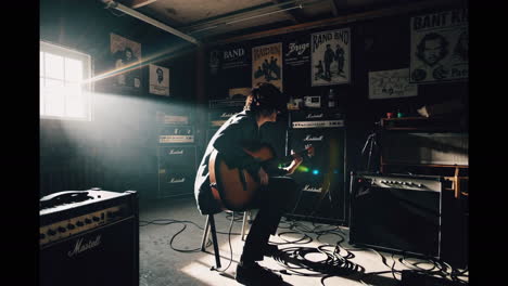 guitarist playing acoustic guitar in home studio