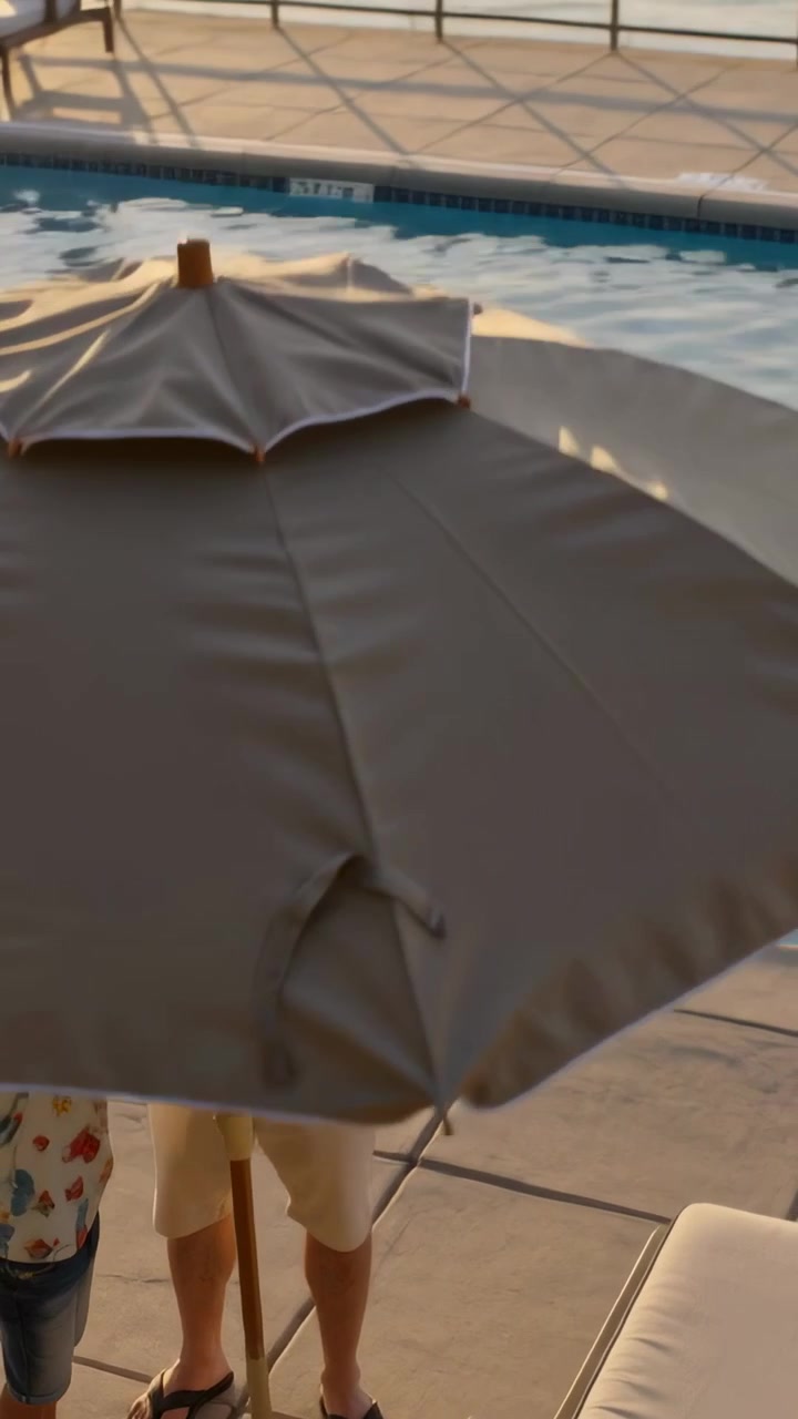 Vertical video: Lifting parasol pole man in polo and kid twisting collar on pool deck for shade