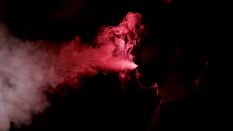 Close-up-of-man-inhaling-an-e-cigarette-vaping-device