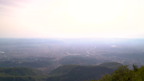 high above view with wide open landscape and polluted city in background