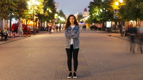 woman standing on city street at night