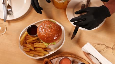 waiter serving a burger and fries