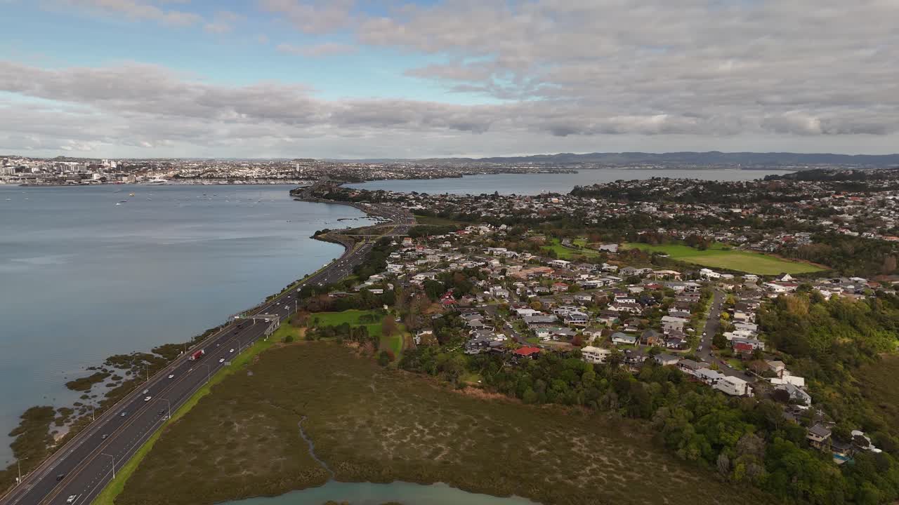 A smooth 4K 60fps reveal shot, as the drone flies backward to showcase the Northcote suburb and its scenic coastline on Shoal Bay. An ideal clip for real estate or depicting suburban life in Auckland
