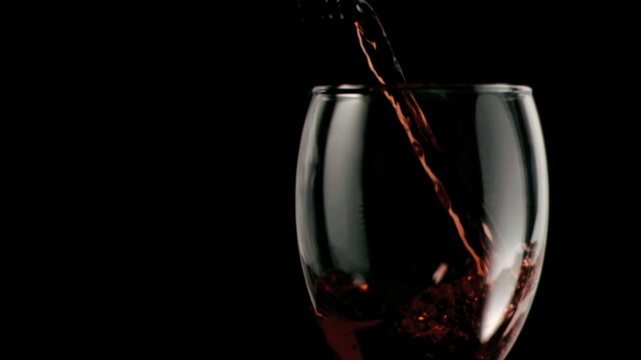 Red wine being poured in super slow motion