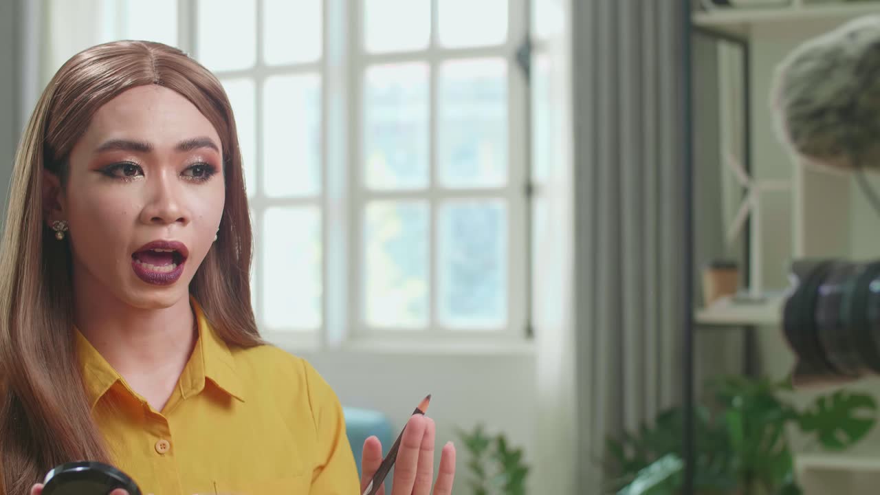 Influencer Young Transgender Woman Blogger Talks About Makeup. Blogger Talks Facial Beauty Treatments. Vlogger Broadcasts How To Use Of Cosmetic In Home Studio