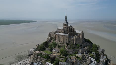 Mont-St-Michael-Tidal-island-Normandy-France-Drone-,-ascending-aerial-,-view-from-air