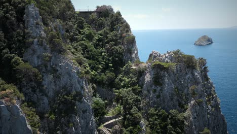 Cliff-drone-shot-revealing-big-rock-in-the-Ocean