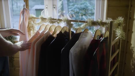 man chooses clothing in his wardrobe for christmas