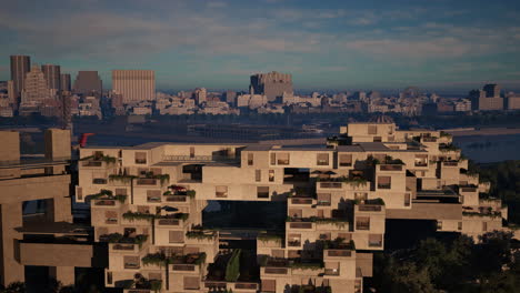 a modern concrete apartment building with balconies and landscaping