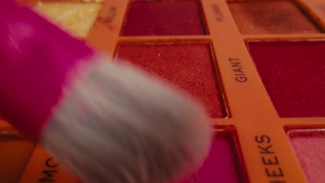 close-up of makeup palette and brush