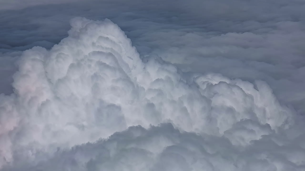 Fluffy clouds with a soft, textured appearance seen from above in the sky