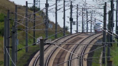 High-speed-electric-passenger-train-passing-under-electric-power-towers