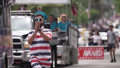man in american flag outfit claps during centerville ohio july 4th parade celebration