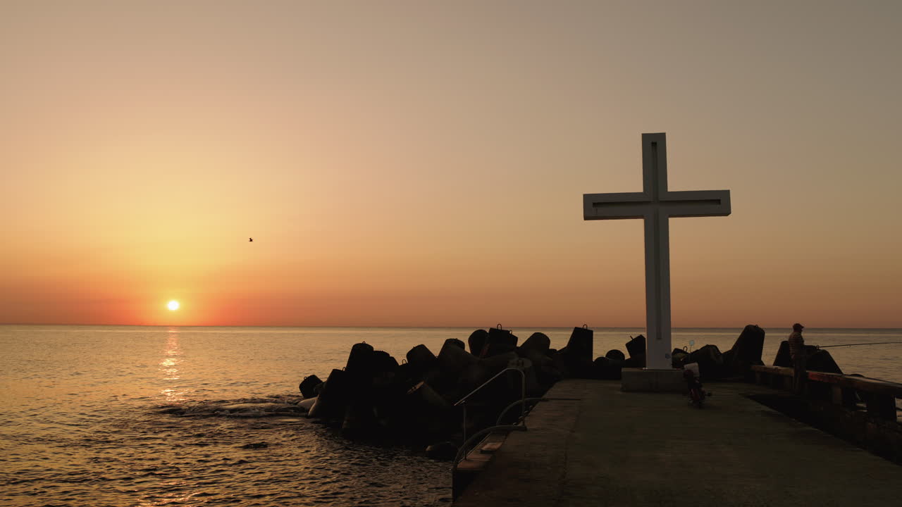 Sunrise at the Sea with a Cross