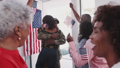 young black soldier returning to a surprise family welcome home party