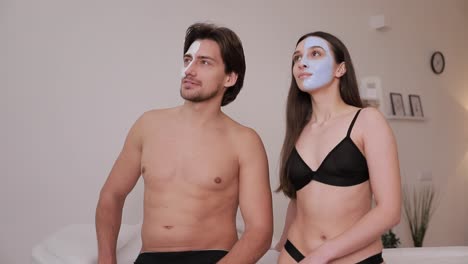 husband and wife use rejuvenating face masks. spa procedures for the face.