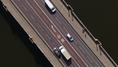 bus driving in bus lane over kingston bridge in london, aerial ascend view