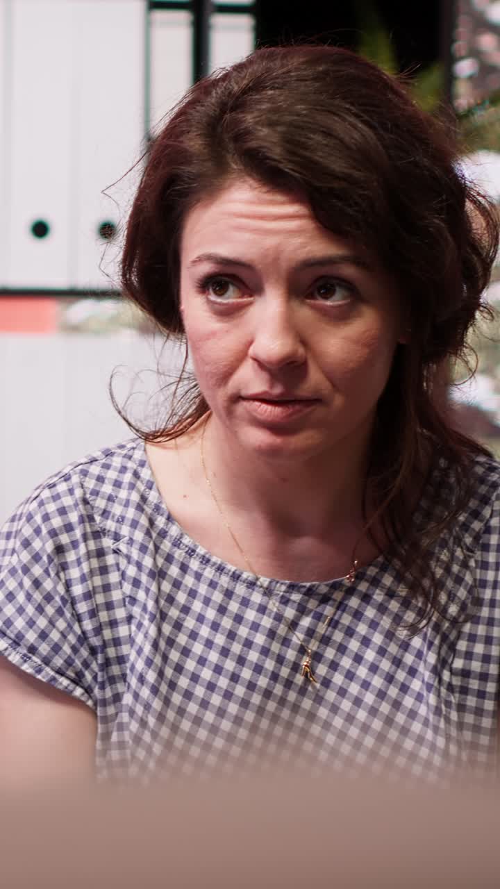 Woman Engaged in Serious Conversation in an Office Setting