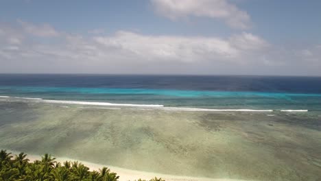 drone shot of the reef and surf at cocos island