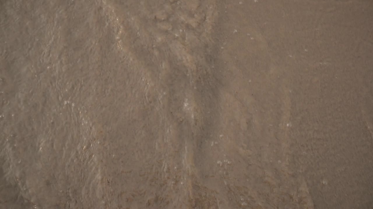 sea waves washing foot print