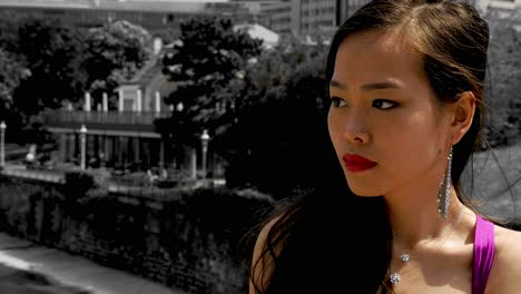 elegant asian woman in vibrant dress by the stadtpark and wienfluss in vienna, sunlight enhancing mood